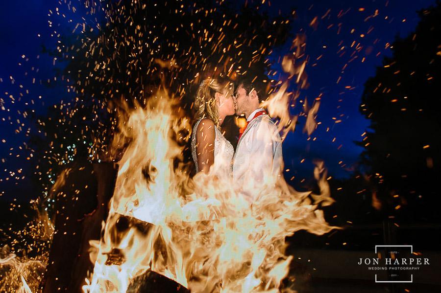 Wedding couple behind bonfire
